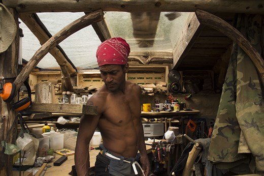 Ayres Gimpson is in his workshop getting ready to start working. 