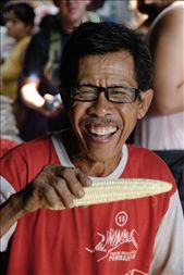 A corn seller laughs heartily, at what I still don't know, just happy with life.  : by joshbfilm, Views[319]