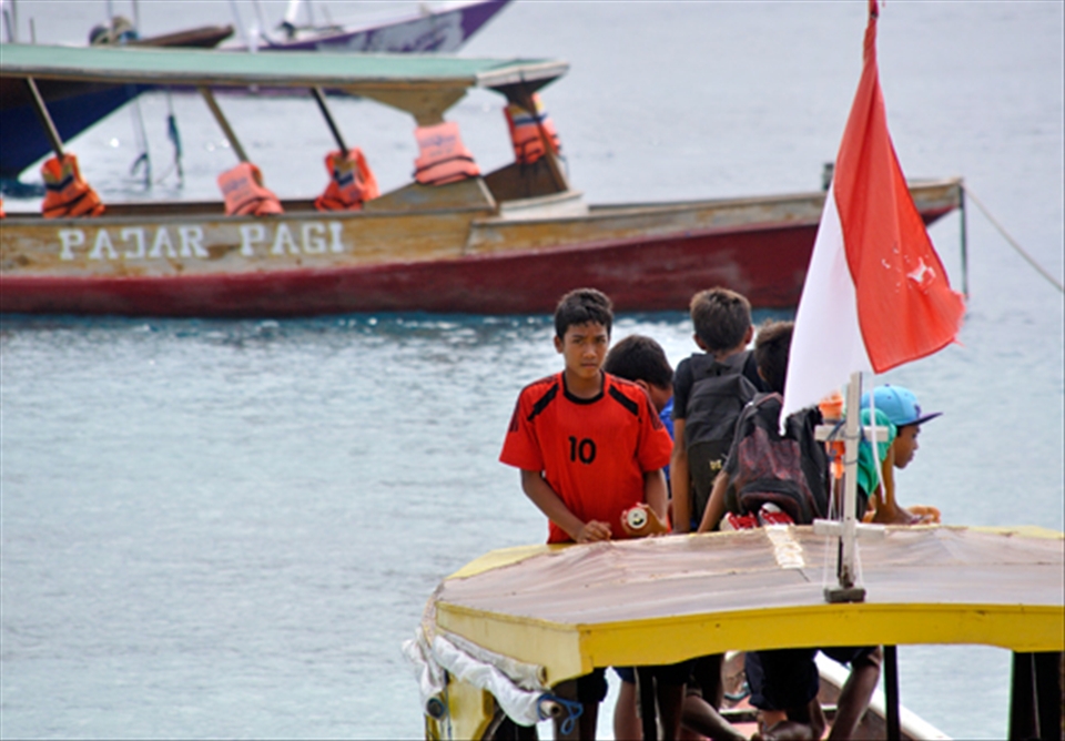 Boys from the Gilis board a boat to go to school in nearby Lombok