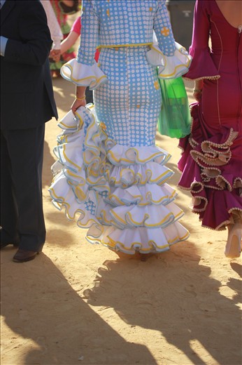 Two women walk to their caseta with the typical mixers for the drink of Fería called “Rebujitos,
