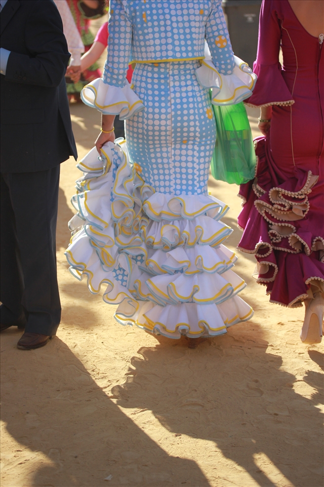 Two women walk to their caseta with the typical mixers for the drink of Fería called “Rebujitos,