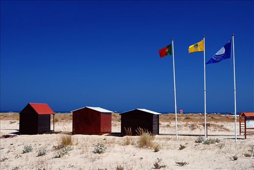 Isle of Tavira is one of the most popular tourism destinies for Camping lovers in Portugal. Three Flags represent Portugal, Algarve region and the town of Tavira, as well as openness to naturism and Camping.