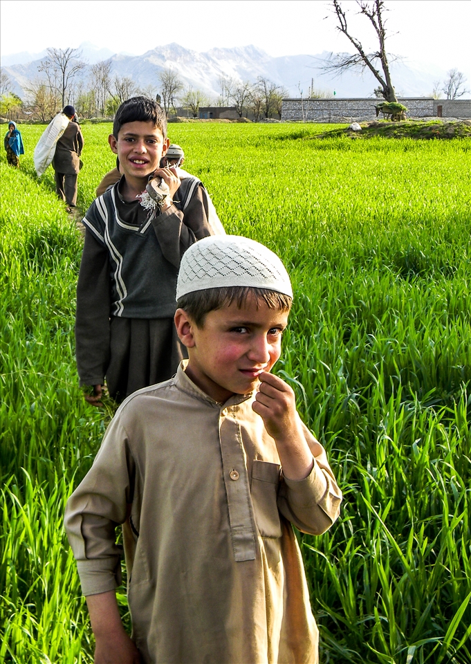 One day children from all corners of the world will come and pick wild flowers with us.
(Children pose for the camera as they make their way home after picking wild flowers and orchards from the lush green farms).