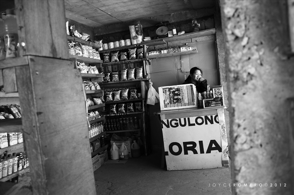 A local vendor seems amused at some tourists stopping by at the highest point of the Philippine Highway System (at Halsema Highway). 

Atok, Benguet, Philippines