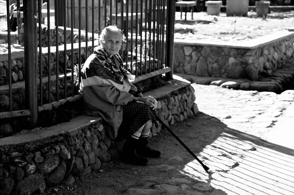 An old woman spends her Sunday afternoon by the church, as tourists make their way to the cemetery behind the church. 

Sagada, Mountain Province, Philippines