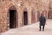 This Moroccan fisherman walks along the street in the Medina quarter (old city section) of the seaside village of Essaouira.  He portrays a solemn figure against the backdrop of monochromatic city walls.: by joymelchiori, Views[1009]