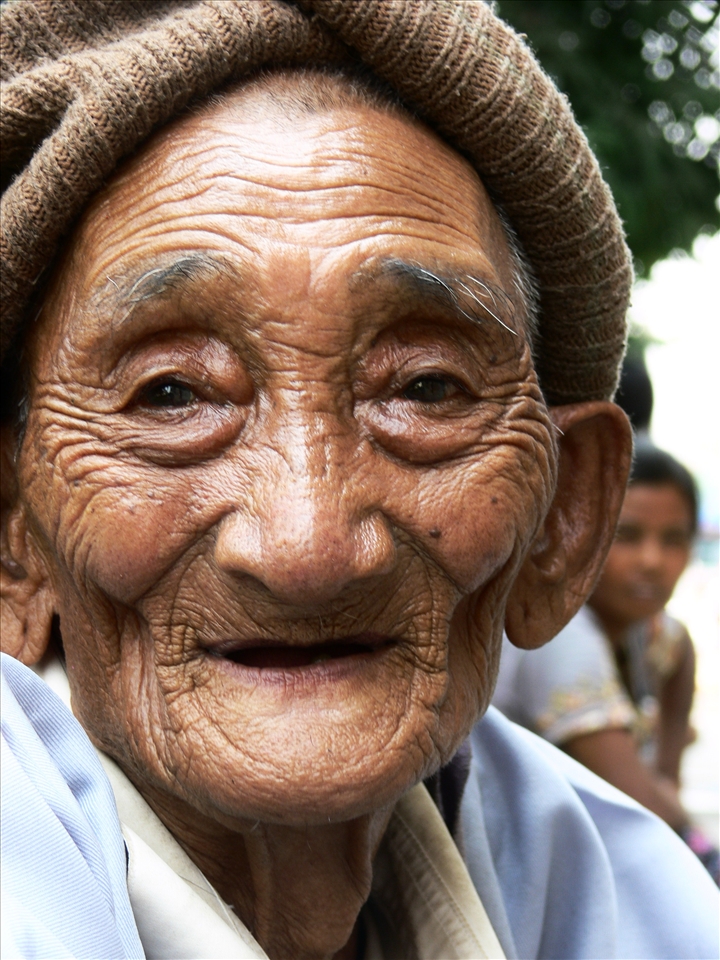 Grateful. His smile speaks a universal language after drinking the offered cola.
