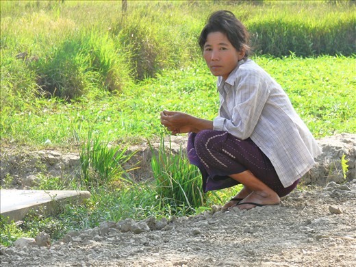 Tentative. Hers is the face of Myanmar, gauging and suspicious of new visitors and western influence.