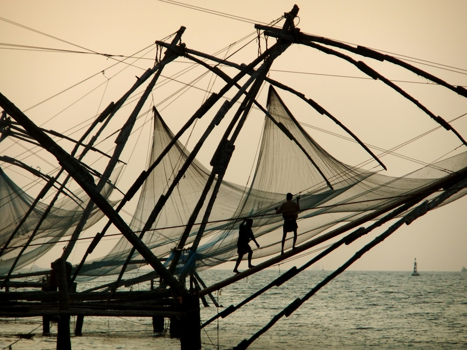 As the sun sets, two fishermen pull in the ropes after an unsuccessful day. 
The Chinese fishing nets (Cheena Vala) decorate the coastline of Fort Cochin, India, and have been used for hundreds of years to catch dinner for locals and the many tourists who flock the area.
