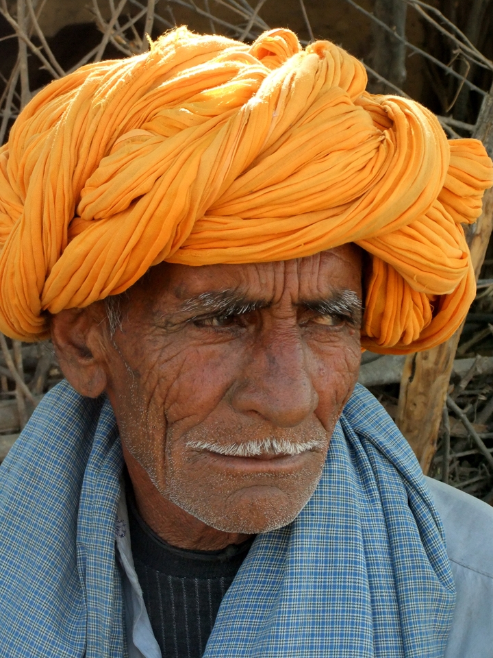 Ajab doesn’t speak English, but his son Nindi tells me that he has spent his entire life in the small town Thikarda, India, which is known for its pottery.  His character lines represent the full life of someone who has known the struggle and joy of life with seven children.