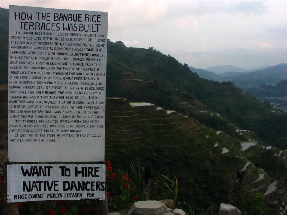 Signage detail the history of the Ifugao rice terraces, but a sign for a job opening also shows the financial opportunities for such areas frequented by tourists. Though tourism creates business opportunities,  the practices of the old traditions might not be of interest to the young locals.  Restaurant cooks and waiters, tour guides, or even souvenir vendors have more appeal.