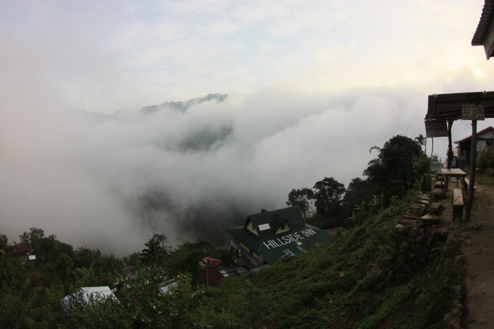 beautiful locations always call to tourists, and tourists will always needs lodgings and accommodations, even in the most rural areas.  The inn is one of many that have sprung up to accommodate tourists on the steep mountainside.  But it has allowed the community to develop from basic huts made of wood to houses and buildings of concrete and steel.