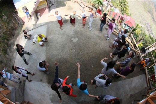 Tourists join the Ifugao in their tribal dance, with companions photographing the moment.  The motions are simple, focusing on out-stretched arms and steps with knee bending. But watching the Ifugaos do it show also the low bend of the knees.  Quite tiring, but to people used to climbing these rice terraces of Banaue,