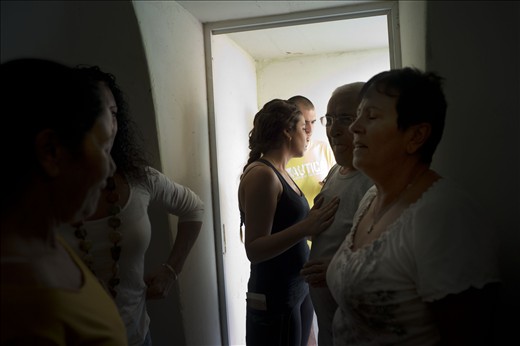 Israeli citizens run to a shelter after hearing sirens of a rocket attack 