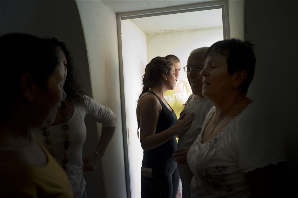 Israeli citizens run to a shelter after hearing sirens of a rocket attack 