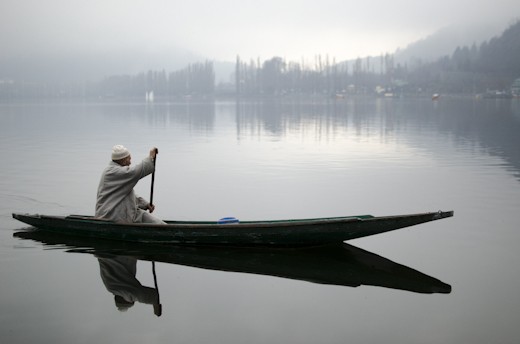A man propelled water taxi looks for any parcels or passengers going ashore