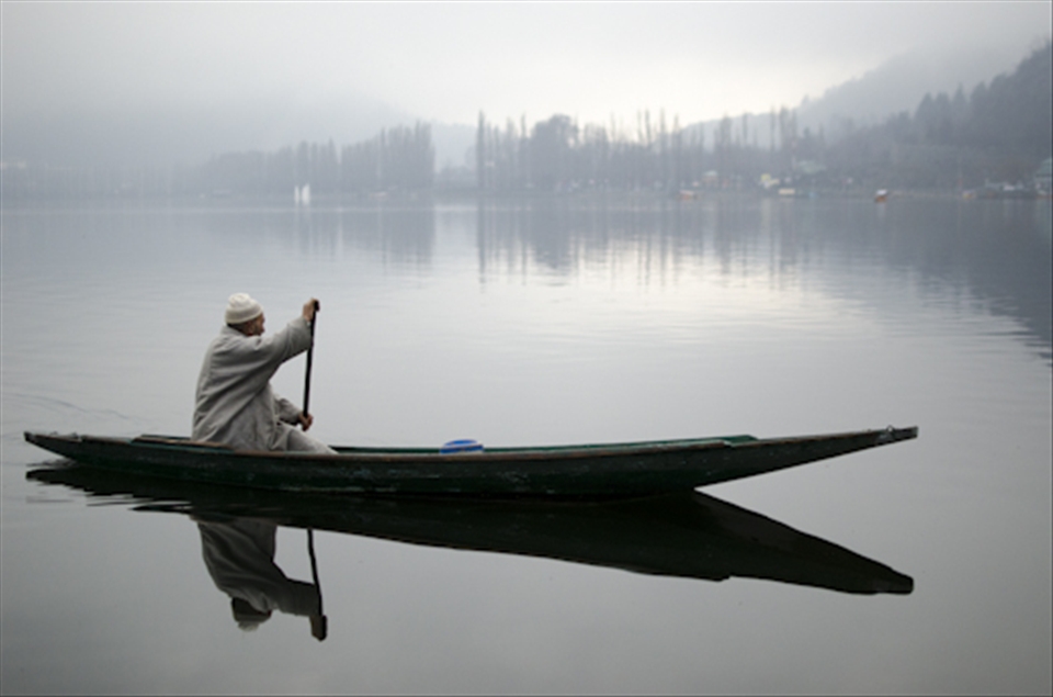 A man propelled water taxi looks for any parcels or passengers going ashore