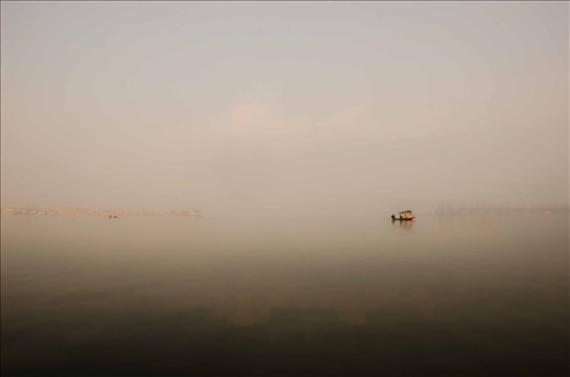 A motarized water taxi in the off-season drifts along looking for passengers