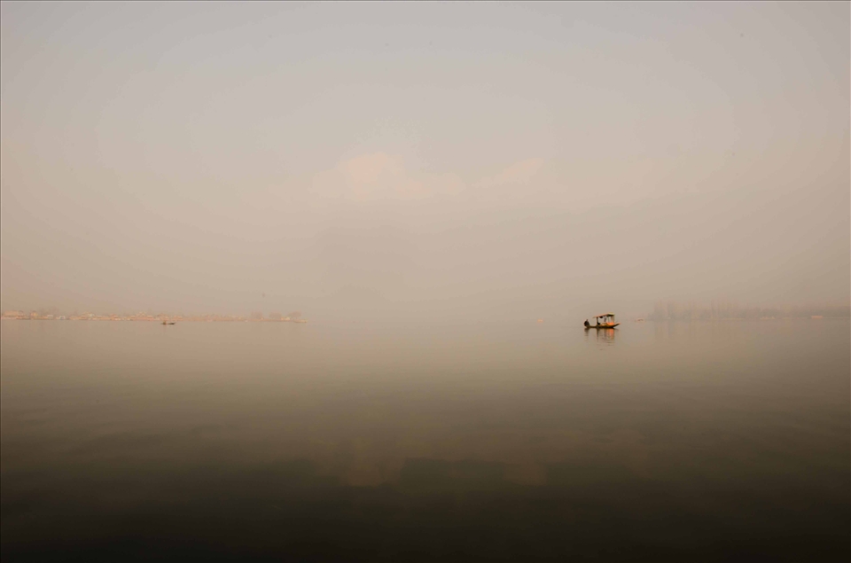 A motarized water taxi in the off-season drifts along looking for passengers
