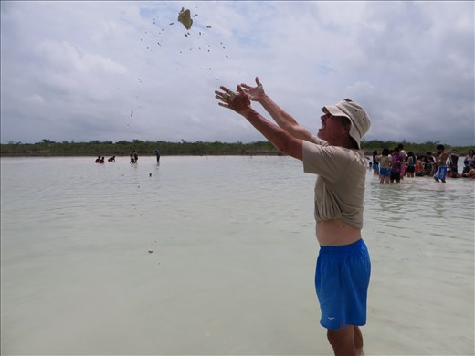 Throwing sand/clay ball in lagoon - Bacalar