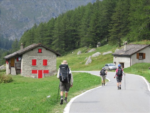 Walking along swiss valley floor to hotel