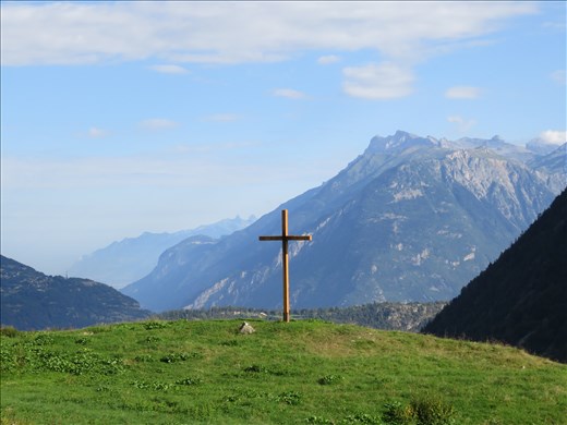 Cross on mtn-side up upward track