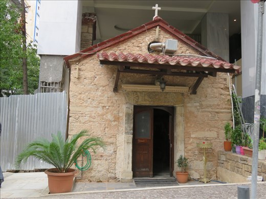 Athens - Small greek church with new hotel built around & over it