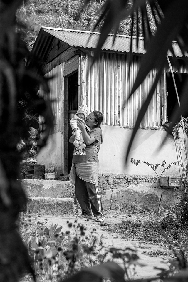 This was the first time I had visited a developing country, and in hindsight I'm so glad it was India. Within the first day I'd had a breakdown when the reality of extreme poverty hit me. And yet reaching the more secluded hills of Kalimpong, I witnessed the positive side of poverty. The appreciation that the people had for every little thing was and is something to learn from. 

One of my biggest learnings was how universal certain traits of humanity were. For instance, the motherly love and pride in this photograph is a familiar subject matter, something we can recognise immediately without needing to know anything more. While India as a 'place' was completely unfamiliar to me, motherly love was as familiar as anything, leaving me questioning the concept of 'place' as location.