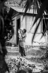 This was the first time I had visited a developing country, and in hindsight I'm so glad it was India. Within the first day I'd had a breakdown when the reality of extreme poverty hit me. And yet reaching the more secluded hills of Kalimpong, I witnessed the positive side of poverty. The appreciation that the people had for every little thing was and is something to learn from. 

One of my biggest learnings was how universal certain traits of humanity were. For instance, the motherly love and pride in this photograph is a familiar subject matter, something we can recognise immediately without needing to know anything more. While India as a 'place' was completely unfamiliar to me, motherly love was as familiar as anything, leaving me questioning the concept of 'place' as location.: by juliezhuphotography, Views[867]