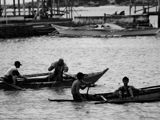 fishermen in action, catching some fish and taking time to leisure bathing.