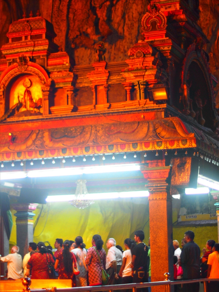 The inside chapel at Batu Cave. The devoutees and the architecture details