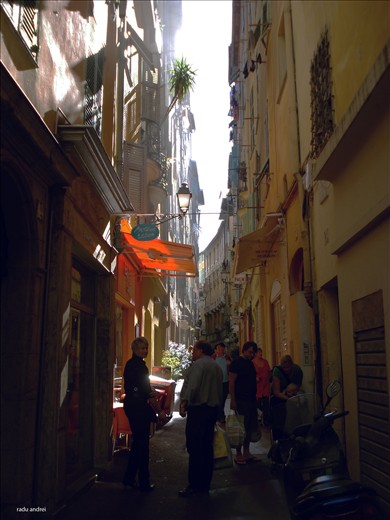 Walking in the afternoon on a typical intricate narrow street of Nice 