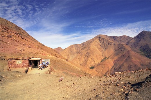 We’d been hiking in the Atlas Mountains for several hours - almost all of it uphill!  The landscape changed slowly, from many trees and plants at the village to just small stands amongst the red tinted soil higher up. As I was tiring, we came to the top of the mountain and I was well rewarded with the stunning view into the next valley and to the surrounding peaks.  What I didn’t expect to see was a little café with stone walls and a patio – and a fantastic view!