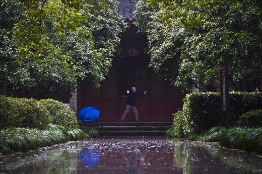 A man practices Tai Chi at a temple in the West Lake district of Hangzhou, China