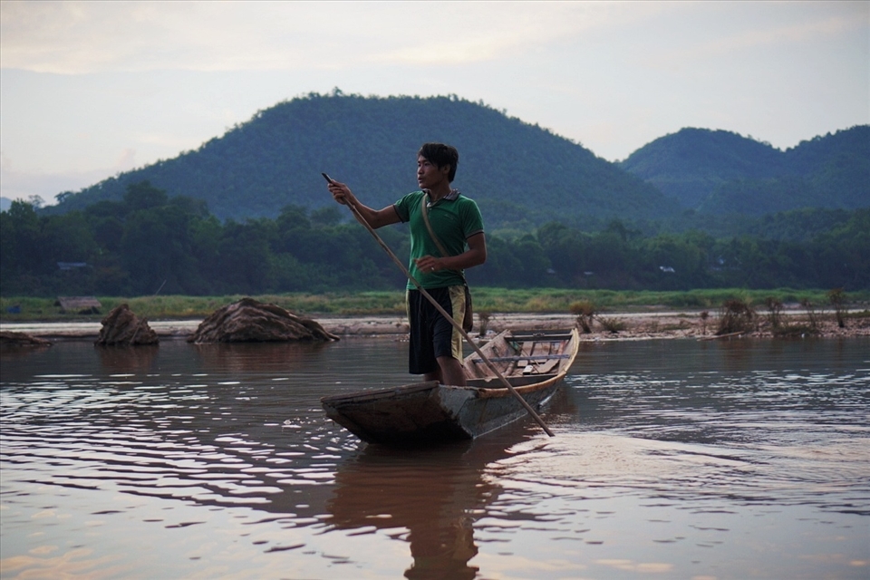 A young man heads home after a day's work in Luang Prabang. The Mekong is the highway, breadbasket and playground of the people who live in settlements along its banks. From childhood, they are taught to work with the natural rhythms of the river, learning to maneuver their long, low boats through the river's flow with confidence and ease.