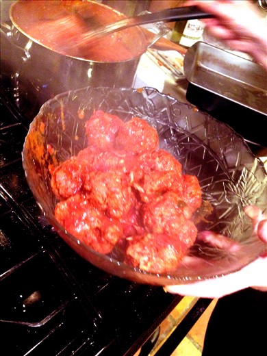 Take meatballs from sauce and put in serving dish, break up pork into sauce