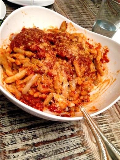 Dress the pasta in a serving dish with sauce and cheese