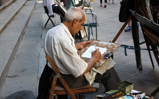 In a alleyway artists gather to try and make a living selling their art