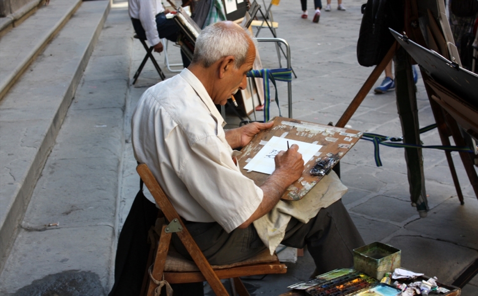 In a alleyway artists gather to try and make a living selling their art