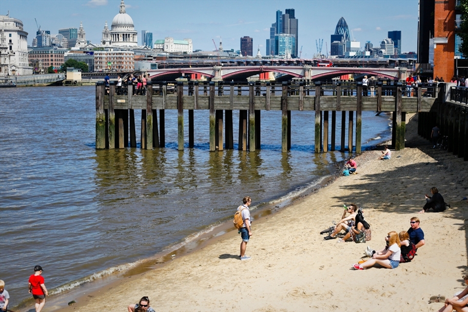 People enjoying one of the hottest days of the summer and seeking a relief along the water.