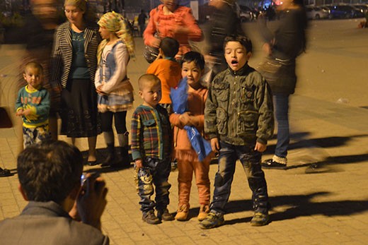 Even just a night out in the town square is a special occasion. Almost as if to compensate for the drab landscape, children and women deck out in bright colours and elaborate outfits, and pose for a photograph in the plaza.