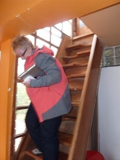 Kathy braving our stairs to our room on arrival.  We have a great room and own bathroom and lovely view of the city and hot hot water.  Only drawback are these stairs!!!!
