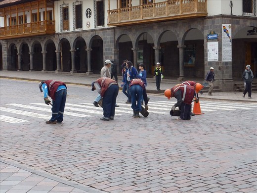 The poor council workers filling gaps in the paved roads.  Huge buckets of hot tar and they then pour them into the cracks.