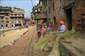 The city streets are full of grains of rice, with women trying to dry it and to sort it out. In the background of the photo, we can see the eastern entrance to the town.: by kalogiorgi, Views[333]