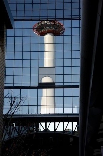 Reflection of Kyoto tower in front of Kyoto station. I visit Kyoto in last November, the blue sky and colorful trees welcome tourists to enjoy this trip.