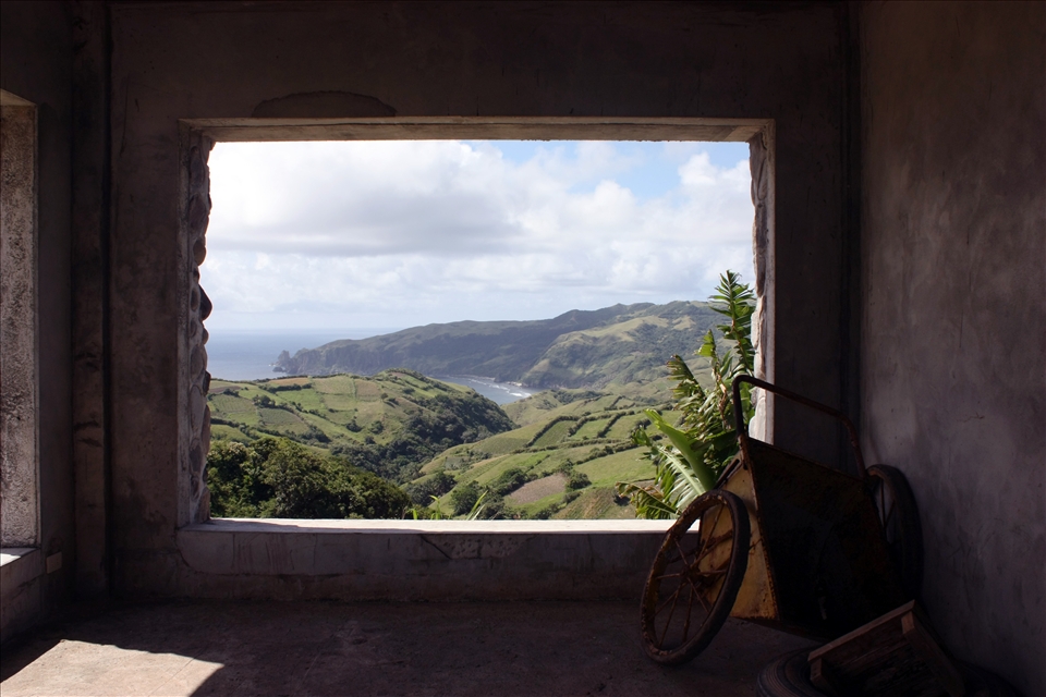 The lush landscape of Batanes meets the sea framed on this windowless wall.