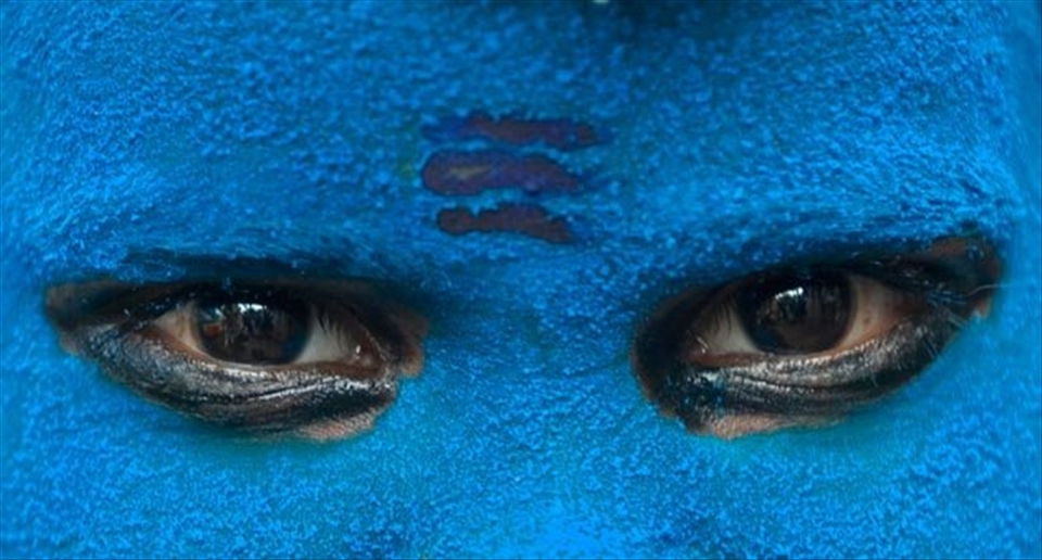 Artistic eyes of a Devotee sadhu of Lord Shiva at Maha Kumbh Mela at Haridwar.

The city of haridwar is flooded with thousands of saints all over the world and the atmosphere near the ganges river is filled with their hymes and prayers to please the God.
It is among this we found such priest which had colored his face blue with three lines on his fore head 
disguising himself into one of the devotees of Lord Shiva. His face gives a sense of cold glaciers and also like poison effect on his face and eyes.Just as lord Shiva turned blue after drinking the poison out of the whole world.
This picture shows a sense of religious faith in god and its divine power