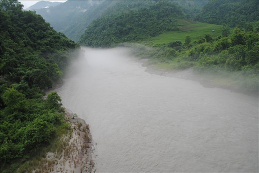 Bliss at Trisuli:

It is green forest area in Nepal on the way to Pokhra from Kathmandu. Trisula flowing at a fast speed roaring at the banks after the first showers of the Monsoons.Looks like the clouds came down the valley and river just to taste its own raindrops. River of clouds overshadowed the flowing beauty beneath.

Beyond from this point the cable car takes you up 1208 metre high to the pilgrim of Manokamna Mandir. the clouds gave a welcome to us as a way to the pious shrine and new world above us.