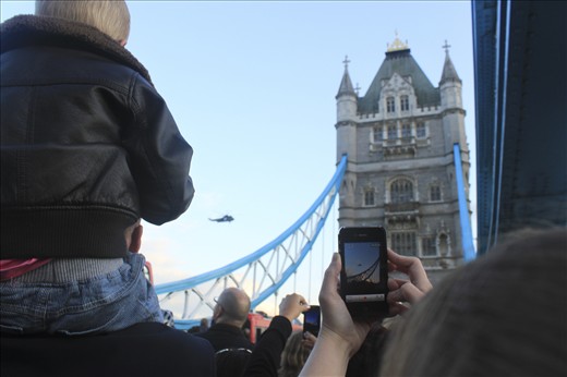 Excitement as a helicopter flies over Tower Bridge.