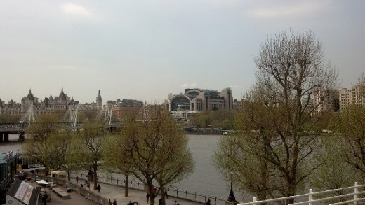 Waterloo bridge with massive corporate buildings behind it.